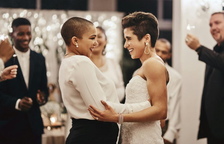 Shot of a newlywed couple dancing while being surrounded by their guests