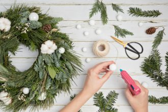 Top view of traditional handmade diy Christmas wreath made with natural elements