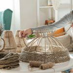 Woman makes handmade diy lamp from jute rope