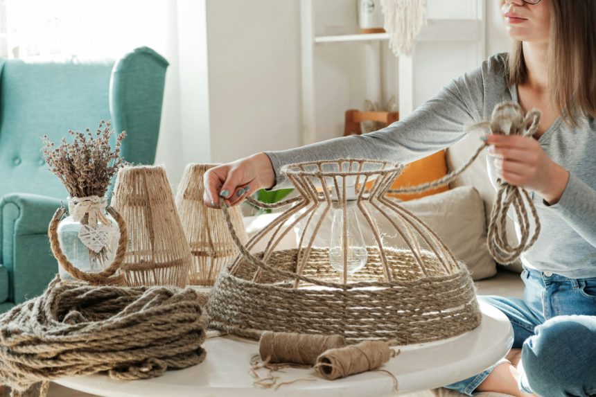 Woman makes handmade diy lamp from jute rope